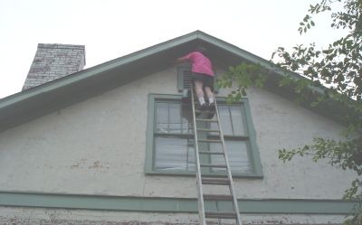 This is me up on a ladder painting the peak of the gable end. I'm not over the hill yet.